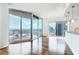 Living room with hardwood floors, floor-to-ceiling windows, and a stunning city view from the attached balcony at 361 17Th Nw St # 1702, Atlanta, GA 30363