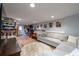 Finished basement with a large sectional sofa, wood-look flooring, and ample space for entertaining at 1885 N Creek Cir, Alpharetta, GA 30009