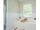 Elegant bathroom with a marble-look bathtub, window view, and a caddy for relaxation at 1885 N Creek Cir, Alpharetta, GA 30009