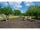 Outdoor community space with playground, pond, lounge furniture, and swings for relaxing and socializing at 1885 N Creek Cir, Alpharetta, GA 30009