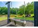 Relaxing swing overlooking the pond in a community area with mature trees and landscaping at 1885 N Creek Cir, Alpharetta, GA 30009