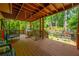 Spacious covered deck with outdoor games including a trampoline, perfect for Gathering fun and entertaining at 1885 N Creek Cir, Alpharetta, GA 30009