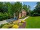 Landscaped garden and driveway leading to a two-story brick home with a bright red door at 1885 N Creek Cir, Alpharetta, GA 30009