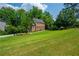 A landscaped yard leads to this two-story brick home with a striking red front door at 1885 N Creek Cir, Alpharetta, GA 30009