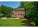 Traditional brick home with manicured lawn and a vibrant red door, perfect for families at 1885 N Creek Cir, Alpharetta, GA 30009
