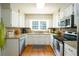 Well-appointed kitchen featuring stainless steel appliances, granite countertops, and hardwood floors at 1885 N Creek Cir, Alpharetta, GA 30009