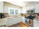 Bright kitchen features granite countertops, stainless steel appliances, and ample natural light at 1885 N Creek Cir, Alpharetta, GA 30009