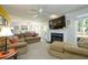 Bright living room with a fireplace, plush seating, and an open layout for modern living at 1885 N Creek Cir, Alpharetta, GA 30009
