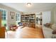 Sun-filled living room featuring hardwood floors, built-in bookcases and yard views at 1885 N Creek Cir, Alpharetta, GA 30009