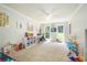 Sunlit playroom featuring carpeted floors, a ceiling fan, and windows overlooking the yard at 1885 N Creek Cir, Alpharetta, GA 30009