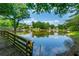 Picturesque pond with bridge overlook, fountain, and serene water reflecting the sky and surrounding trees at 1885 N Creek Cir, Alpharetta, GA 30009
