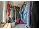 Organized walk-in closet with hanging clothes, shelves, and storage bins, maximizing storage space at 1885 N Creek Cir, Alpharetta, GA 30009
