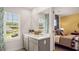 Bathroom featuring double sinks, a large mirror, and ample natural light from the adjacent window at 3076 Yellowhammer Dr, Marietta, GA 30064