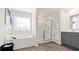 Clean bathroom featuring a tub, glass shower, and vanity with plenty of natural light at 3076 Yellowhammer Dr, Marietta, GA 30064