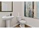 Neat powder room with a pedestal sink, toilet, and modern wall art at 3076 Yellowhammer Dr, Marietta, GA 30064