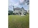 Well-maintained backyard features a patio, lush lawn, and mature landscaping at 3381 Walkers Ridge Rd, Dacula, GA 30019