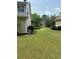 Manicured backyard with lush green grass, trees, and beautiful landscaping at 3381 Walkers Ridge Rd, Dacula, GA 30019