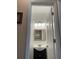 Bright half-bathroom features a sink with storage, modern lighting, and a framed mirror at 3381 Walkers Ridge Rd, Dacula, GA 30019