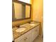 Bathroom featuring a double sink vanity with granite countertops and a framed mirror at 3381 Walkers Ridge Rd, Dacula, GA 30019