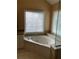 A luxurious bathroom featuring a tiled jacuzzi tub with a large window and tiled floors at 3381 Walkers Ridge Rd, Dacula, GA 30019