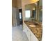 Granite vanity with cabinets and drawers with white tiled floors in primary bathroom at 3381 Walkers Ridge Rd, Dacula, GA 30019