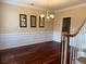 Elegant dining room with dark wood floors, wainscoting and a chandelier, perfect for formal gatherings at 3381 Walkers Ridge Rd, Dacula, GA 30019