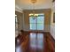 Bright dining room with wainscoting, hardwood floors, chandelier and a large window at 3381 Walkers Ridge Rd, Dacula, GA 30019