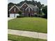 A traditional two-story brick home with a manicured front lawn at 3381 Walkers Ridge Rd, Dacula, GA 30019
