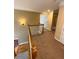 Second-floor hallway with neutral carpeting, a light fixture, and a wooden railing at 3381 Walkers Ridge Rd, Dacula, GA 30019