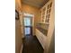 Hallway with tile floors and granite counters leads to dining area with chandelier at 3381 Walkers Ridge Rd, Dacula, GA 30019