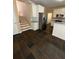 Kitchen featuring stainless steel refrigerator, white cabinets and tiled floors, with staircase at 3381 Walkers Ridge Rd, Dacula, GA 30019