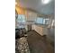Open kitchen with white cabinets, granite countertops, stainless appliances, and tile floors at 3381 Walkers Ridge Rd, Dacula, GA 30019
