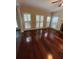 Bright living room with large windows, fireplace, and gleaming hardwood floors at 3381 Walkers Ridge Rd, Dacula, GA 30019