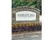 Stone entrance sign for Hamilton Mill, enhanced by landscaping with colorful plantings and flowers at 3381 Walkers Ridge Rd, Dacula, GA 30019