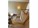 Looking down a staircase with light wood treads, a carpeted middle landing, and white balusters at 3381 Walkers Ridge Rd, Dacula, GA 30019