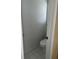 Small water closet with a standard white toilet and white tile flooring at 3381 Walkers Ridge Rd, Dacula, GA 30019