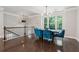Stylish dining area with hardwood floors, a modern light fixture, and an open view of the staircase at 4012 Townsend Ln, Dunwoody, GA 30346