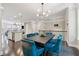 Open-concept dining room with modern lighting, hardwood floors, and a view of the adjacent kitchen at 4012 Townsend Ln, Dunwoody, GA 30346