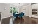 Elegant dining room featuring hardwood floors, a modern chandelier, and a large window overlooking lush greenery at 4012 Townsend Ln, Dunwoody, GA 30346