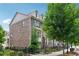 Inviting brick townhome with a gated yard, mature tree, and a beautifully landscaped entryway at 4012 Townsend Ln, Dunwoody, GA 30346