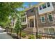 Charming brick townhome featuring multiple stories and a gated front yard with beautiful landscaping at 4012 Townsend Ln, Dunwoody, GA 30346