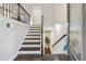 Bright foyer with hardwood floors, a staircase with dark wood railings, and natural light from the front door at 4012 Townsend Ln, Dunwoody, GA 30346