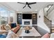 Stylish living room with hardwood floors, a fireplace, and a mounted TV at 4012 Townsend Ln, Dunwoody, GA 30346