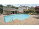 Community pool with bath house, tanning deck, and exterior view of surrounding apartment homes at 4012 Townsend Ln, Dunwoody, GA 30346