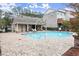 Community pool with brick surround, covered lounge area, and sunbathing chairs for residents' enjoyment at 4012 Townsend Ln, Dunwoody, GA 30346