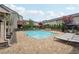 Exterior view of a community pool area featuring chaise lounges, tables, and well-manicured landscaping at 4012 Townsend Ln, Dunwoody, GA 30346