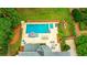 Aerial view of a backyard featuring a large pool, lounge areas, and meticulously maintained landscaping at 5963 Wild River Vw, Sugar Hill, GA 30518
