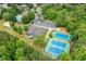Aerial view showcasing tennis courts, a playground, a pool, and parking within a residential community at 5963 Wild River Vw, Sugar Hill, GA 30518