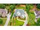 Aerial view of a home featuring a pool, lush backyard, manicured landscaping, and a circular driveway at 5963 Wild River Vw, Sugar Hill, GA 30518
