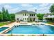 Backyard featuring a pool, patio area with furniture, and expansive green lawn for entertainment and relaxation at 5963 Wild River Vw, Sugar Hill, GA 30518